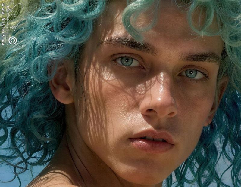 hyperrealistic photograph of an attractive young attractive male who is looking at the viewer. he has a huge improbable green and blue unruly hairdo.